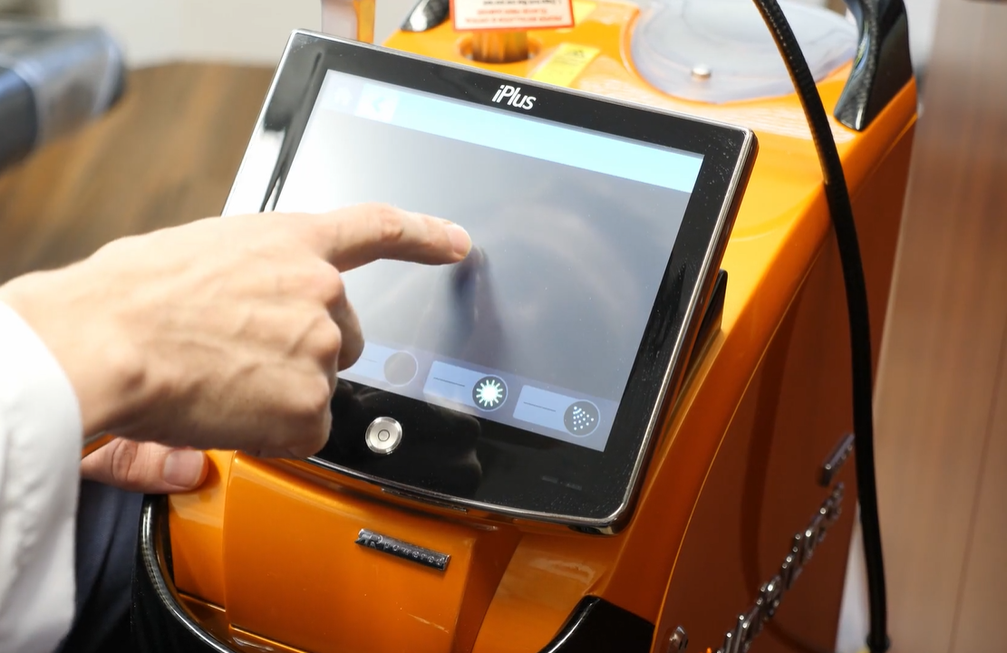 Orange waterlase machine in use at a boston dentist office